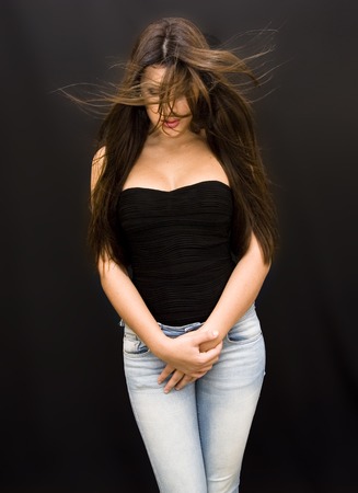 Beautiful Brunette Girl over black の写真素材