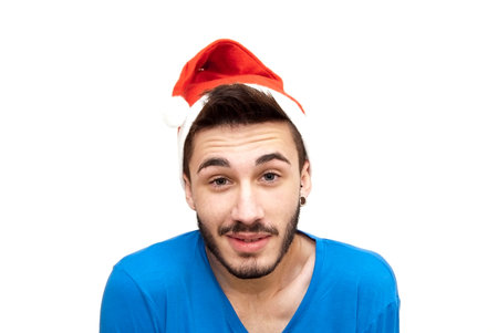 Handsome man in christmas hat over white の写真素材