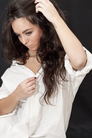 Portrait of  Beautiful Brunette Girl With a  White Shirt of Man  over black の写真素材