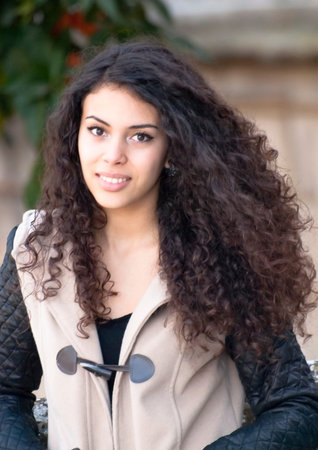 Beautiful latin woman in a park in autumnの写真素材