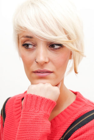 Beautiful woman with short white hair resting his chin in his hand on white background