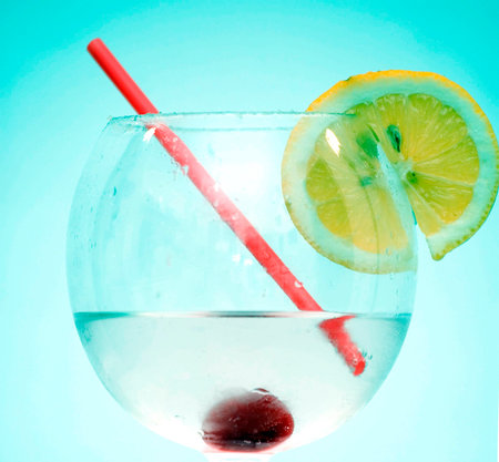 Cocktail with lemon slice, cherry and a strawの写真素材