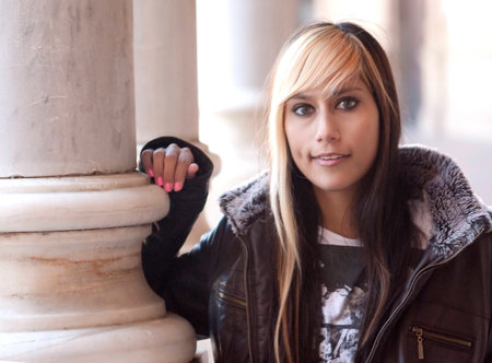 Portrait of Beautiful latin woman in a park in autumnの写真素材