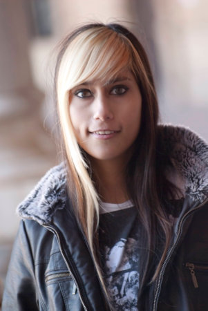 Portrait of Beautiful latin woman in a park in autumnの写真素材