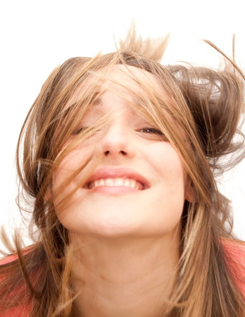 Beautiful Brunette Girl with her hair in motion over white backgroundの写真素材