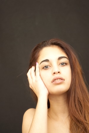 Beautiful girl with blue eyes over black backgroundの写真素材