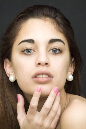 Beautiful girl with blue eyes over black backgroundの写真素材