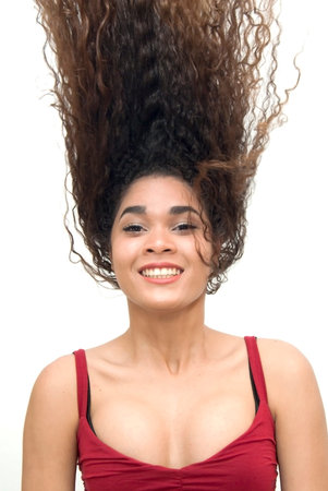 Beautiful latin girl with her hair in motion over white background