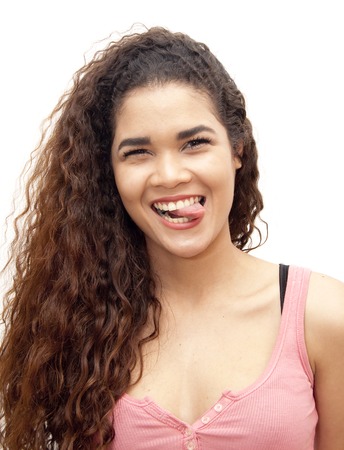 Beautiful latin girl with his tongue out of his mouth over white backgroundの写真素材