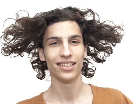 Handsome man moving her hair over white backgroundの写真素材