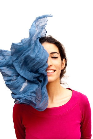 Portrait of Beautiful Young Woman With A Scarf falling over Her Face Over White Backgroundの写真素材