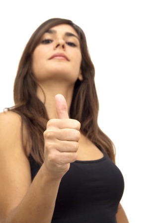 Portrait of Beautiful Young Woman  With The Thumb Upwards Over White Backgroundの写真素材