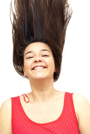 Portrait of Nice Young Woman Shaking Her Hair Over White Backgroundの写真素材