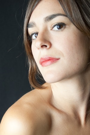 Portrait of Beautiful Young Woman Over Black Backgroundの写真素材