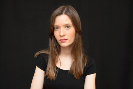 Portrait of Beautiful Young Woman Over Black Background
