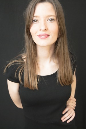 Portrait of Beautiful Young Woman Over Black Backgroundの写真素材