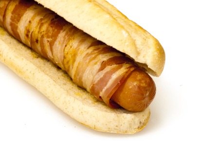 Hot dog with bacon on a white background の写真素材