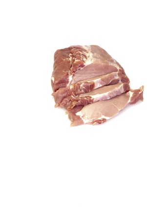 Piece of raw meat cut into steaks on white background の写真素材