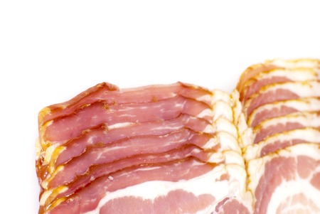 Slices of bacon on white background の写真素材