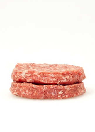 Raw hamburger over white backgroundの写真素材