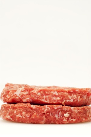 Raw hamburger over white backgroundの写真素材