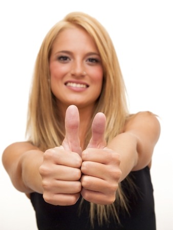 Portrait of Beautiful Blonde Woman  With The Thumb Upwards Over White Backgroundの写真素材