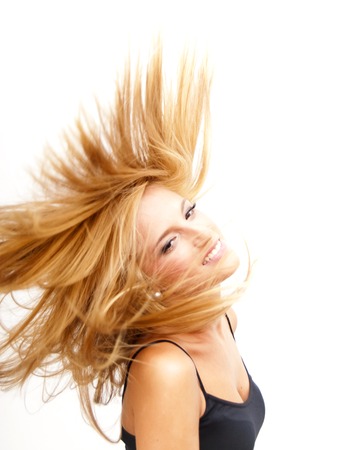 Portrait of Beautiful Blonde Woman Shaking Her Hair Over White Backgroundの写真素材
