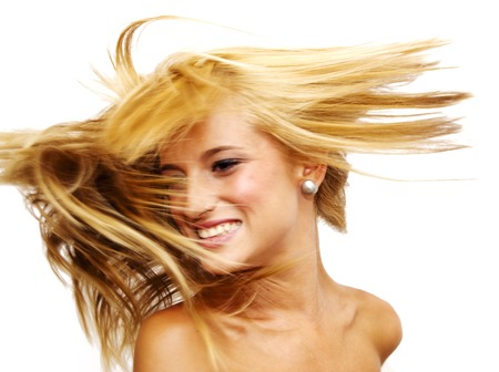Portrait of Beautiful Blonde Woman Shaking Her Hair Over White Backgroundの写真素材