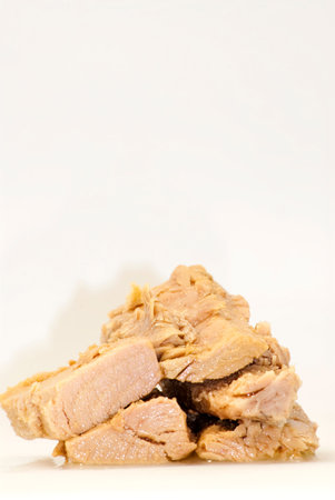Group of pieces of tuna in olive oil over white background の写真素材