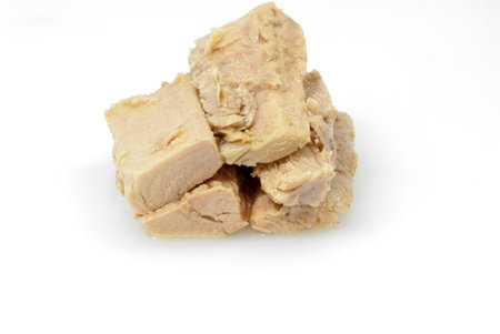 Group of pieces of tuna in olive oil over white background の写真素材