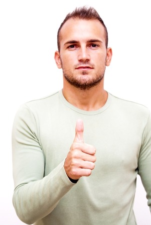 Handsome man with the thumb upwards over white backgroundの写真素材