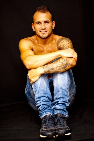 Handsome man shirtless over black backgroundの写真素材