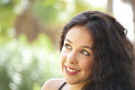 Beautiful woman in a park on a sunny dayの写真素材