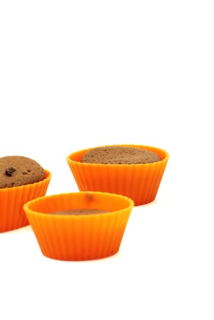Chocolate muffins in silicone holders on white backgroundの写真素材