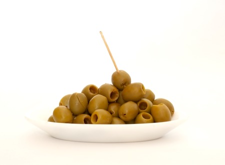 Raw olives without bones with toothpick over white backgroundの写真素材