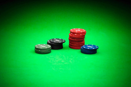 Poker chips over green background