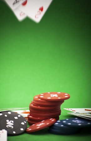 Cards and gambling chips over green backgroundの写真素材