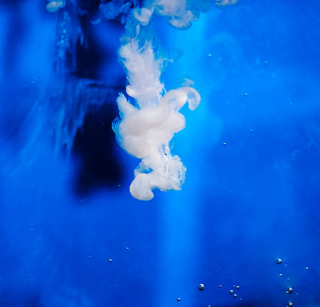 Milk jet over blue backgroundの写真素材