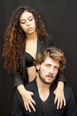 Beautiful portrait of a loving couple  on black background.の写真素材