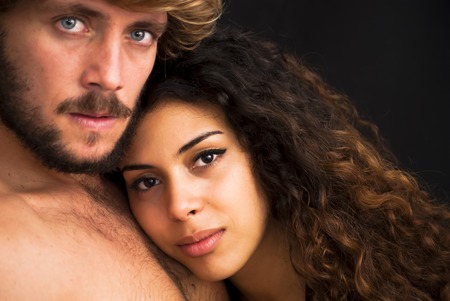 Beautiful portrait of a loving couple  on black background.の写真素材