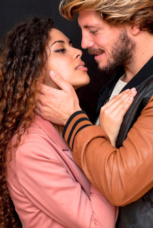 Beautiful portrait of a loving couple  on black background.