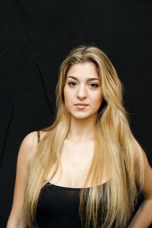 Portrait of Beautiful Young Woman Over Black Backgroundの写真素材