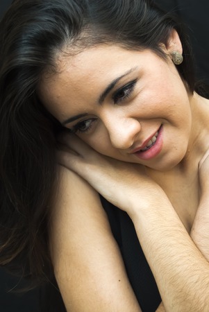 Portrait of Beautiful Young Woman Over Black Backgroundの写真素材