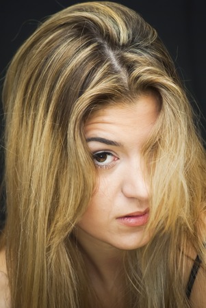 Portrait of Beautiful Young Woman Over Black Backgroundの写真素材