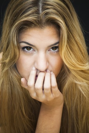 Portrait of Beautiful Young Woman Over Black Backgroundの写真素材