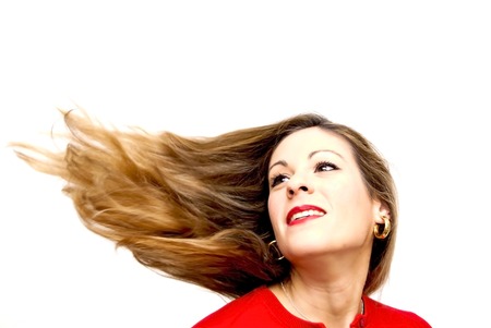 Portrait of Beautiful Young Woman Shaking Her Hair Over White Backgroundの写真素材