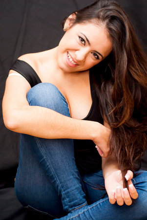 Portrait of Beautiful Young Woman Over Black Backgroundの写真素材