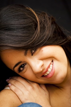 Portrait of Beautiful Young Woman Over Black Backgroundの写真素材