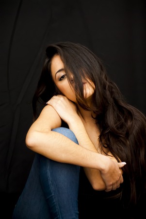 Portrait of Beautiful Young Woman Over Black Backgroundの写真素材