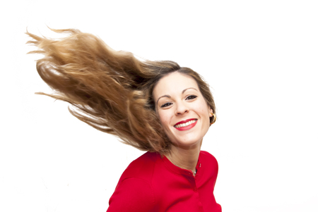 Portrait of Beautiful Young Woman Shaking Her Hair Over White Backgroundの写真素材